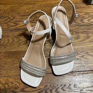 White and silver woman’s heels